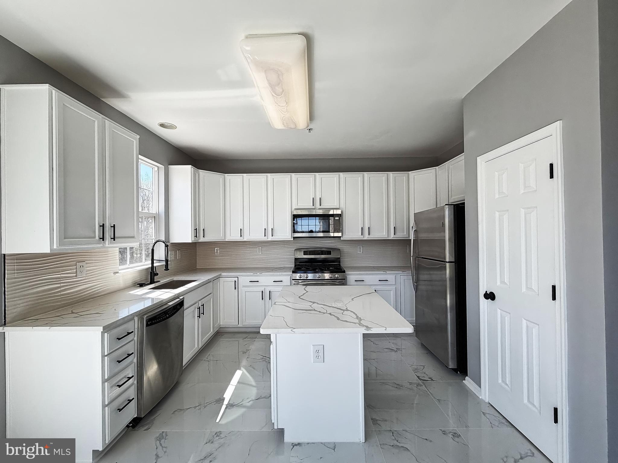 1816 Graymount Way Edgewood, MD 21040 - Photo 7 of 23 a kitchen with a sink stove and refrigerator