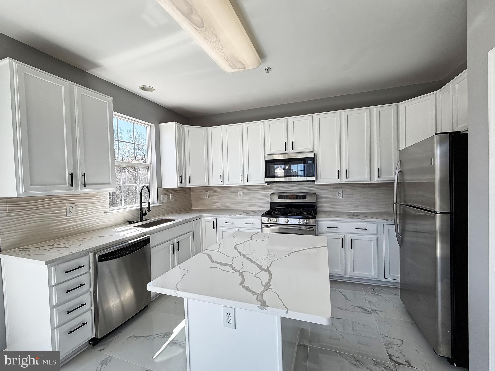 1816 Graymount Way Edgewood, MD 21040 - Photo 8 of 23 a kitchen with a sink a stove a refrigerator and white cabinets