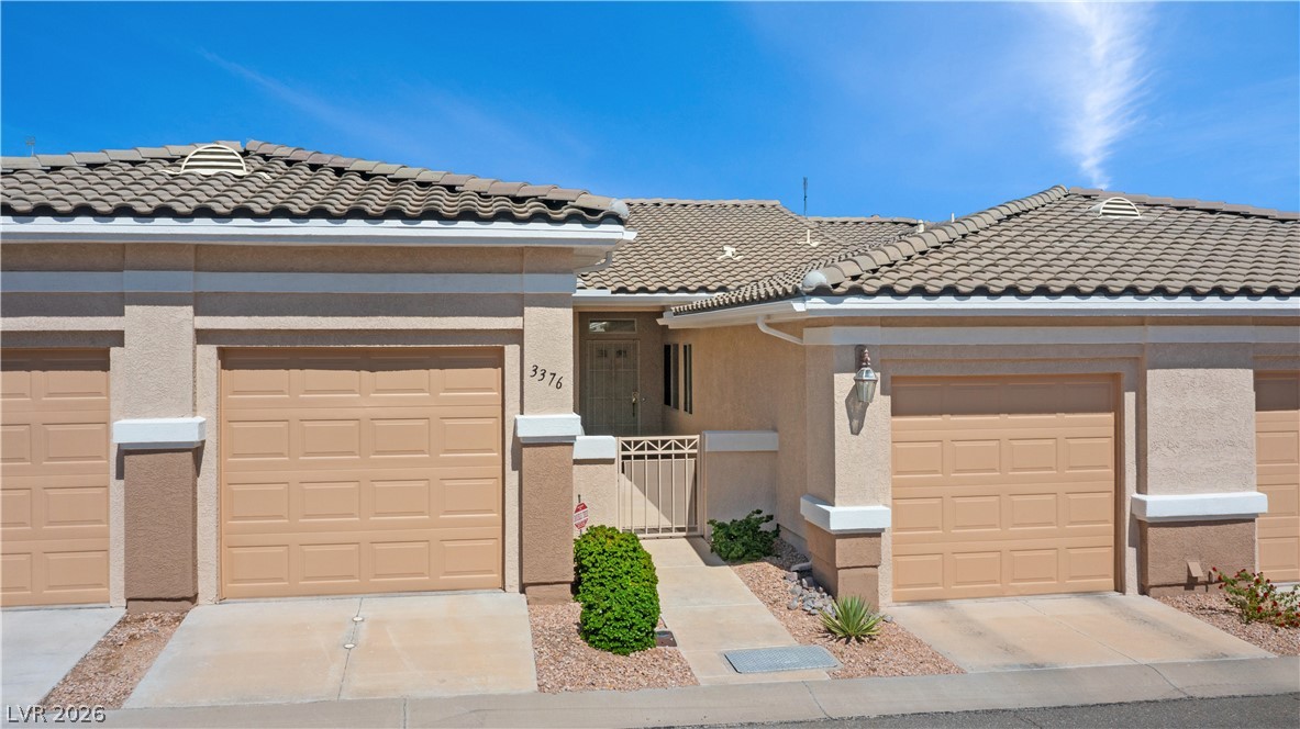 3376 Partridge Run Street Laughlin, NV 89029 - Photo 63 of 92 A well-maintained stucco exterior welcomes you to this desert oasis, complete with attached garages and a tiled roof.