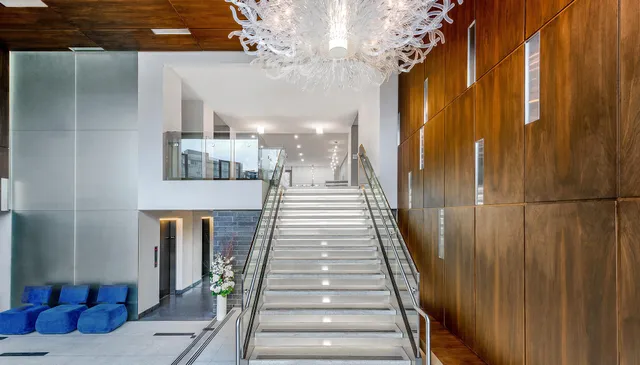 a view of a hallway with wooden floor and staircase