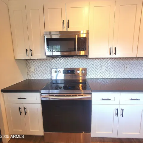 a kitchen with a stove and a microwave