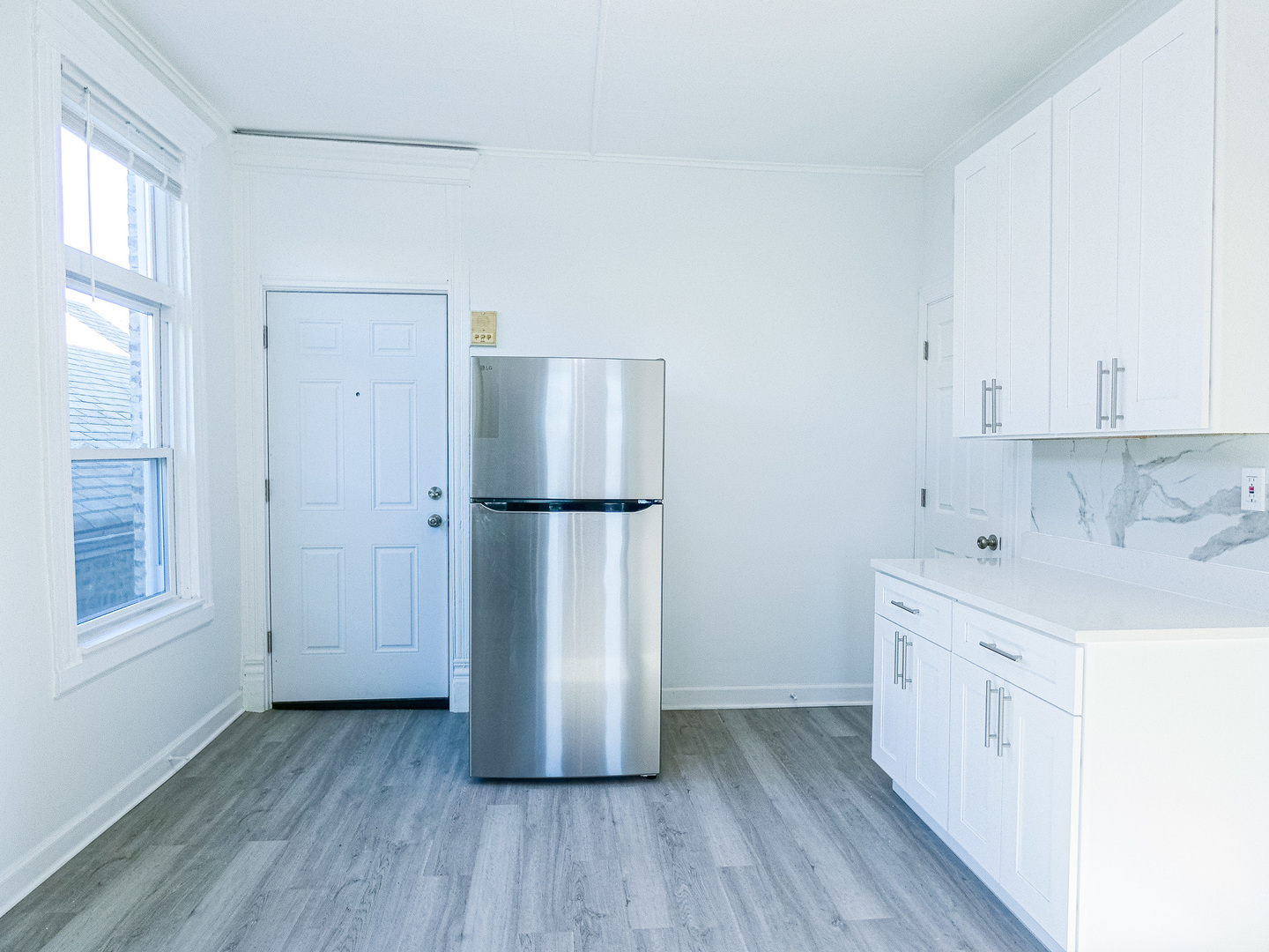 2044 West 19th Street, Unit 3R Chicago, IL 60608 - Photo 4 of 11 a kitchen with a refrigerator a sink and wooden floor