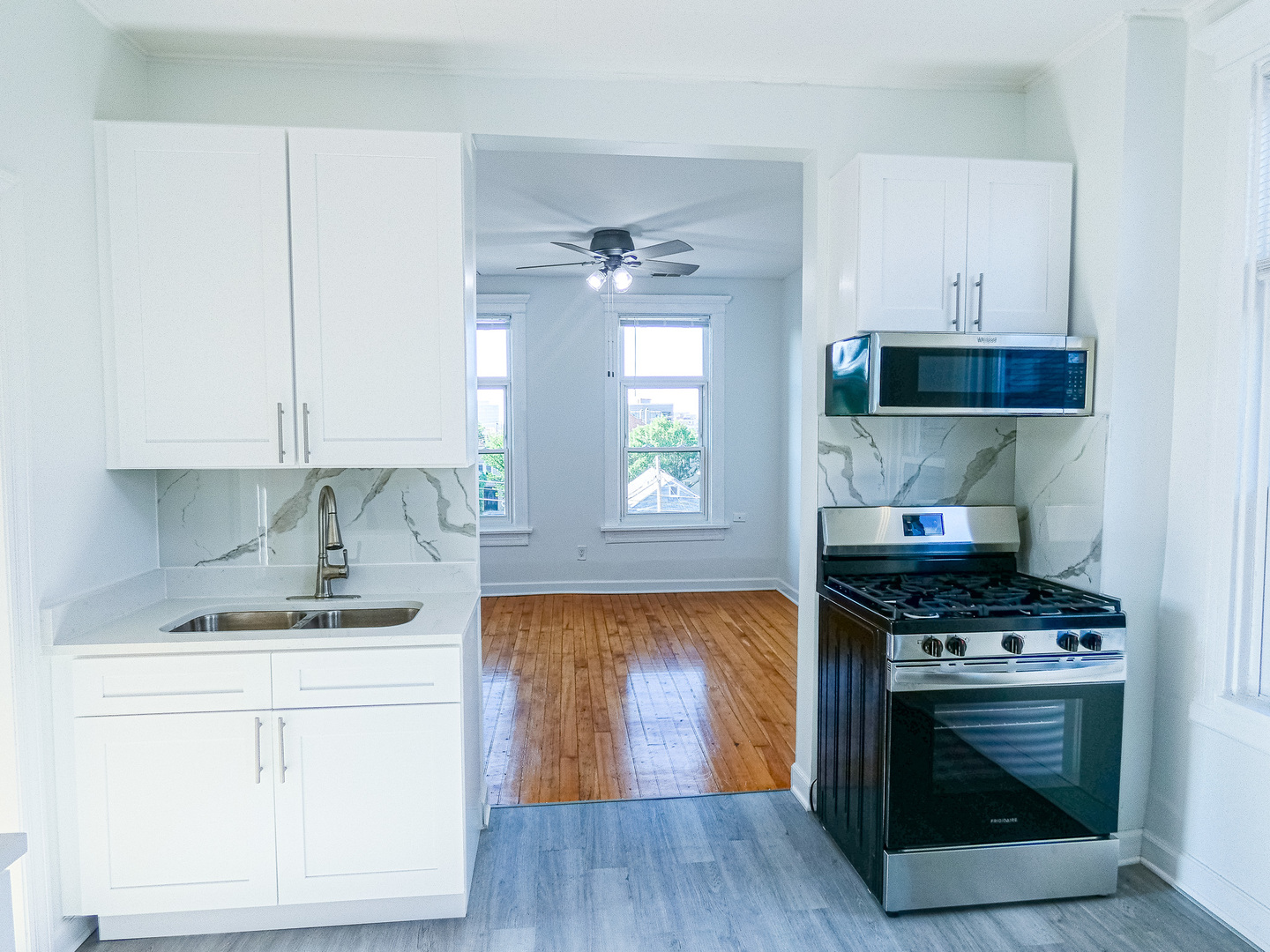2044 West 19th Street, Unit 3R Chicago, IL 60608 - Photo 5 of 11 a kitchen with a stove cabinets and wooden floor