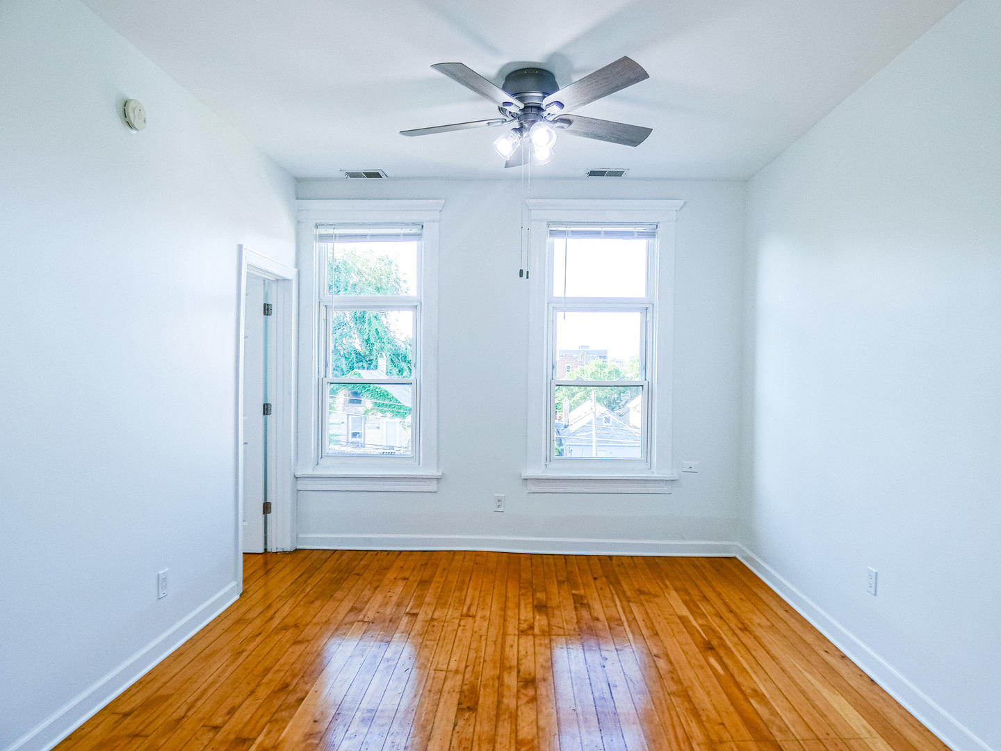 2044 West 19th Street, Unit 3R Chicago, IL 60608 - Photo 6 of 11 wooden floor in an empty room with a window