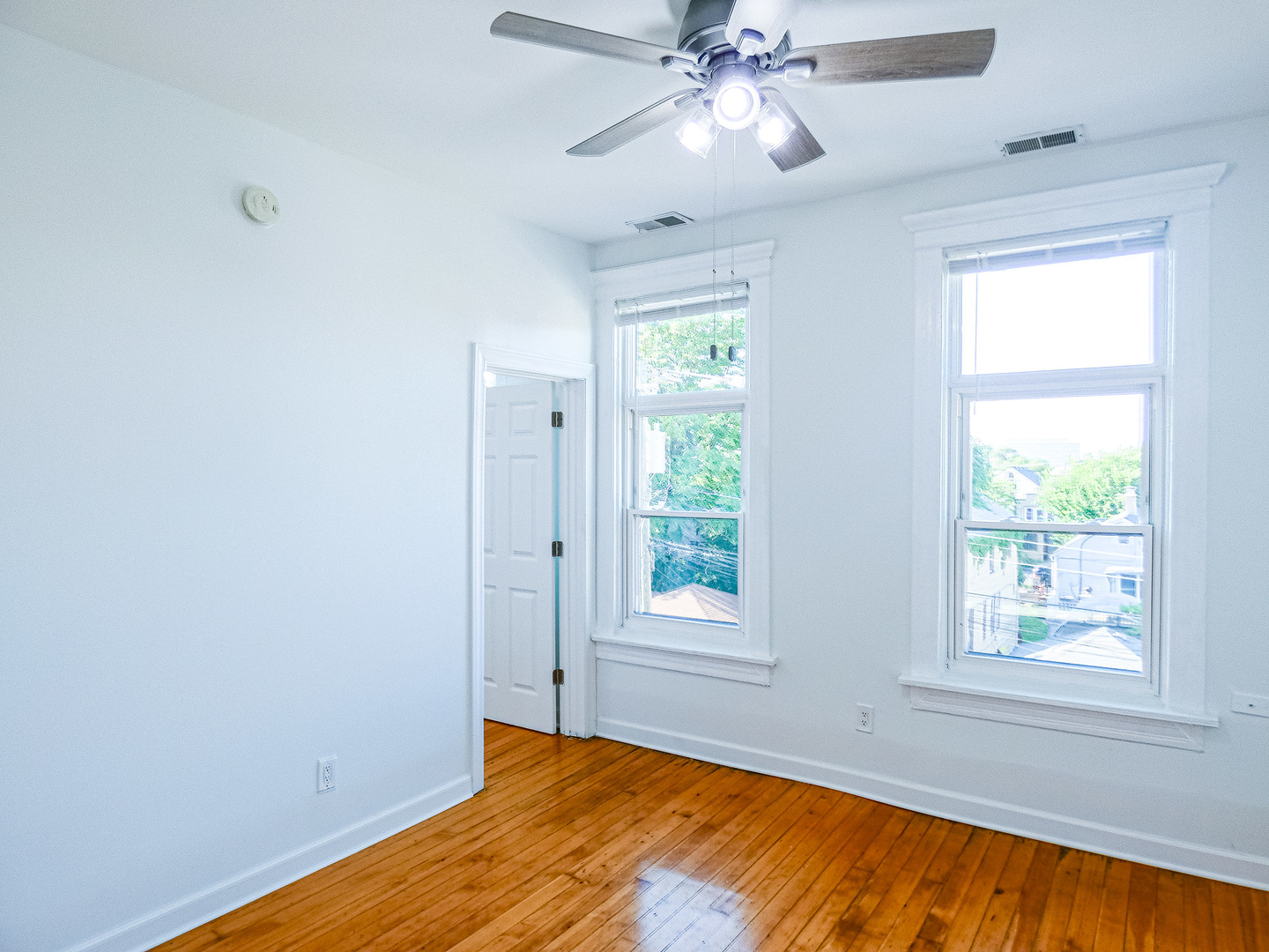 2044 West 19th Street, Unit 3R Chicago, IL 60608 - Photo 7 of 11 a view of an empty room with chandelier fan and a window