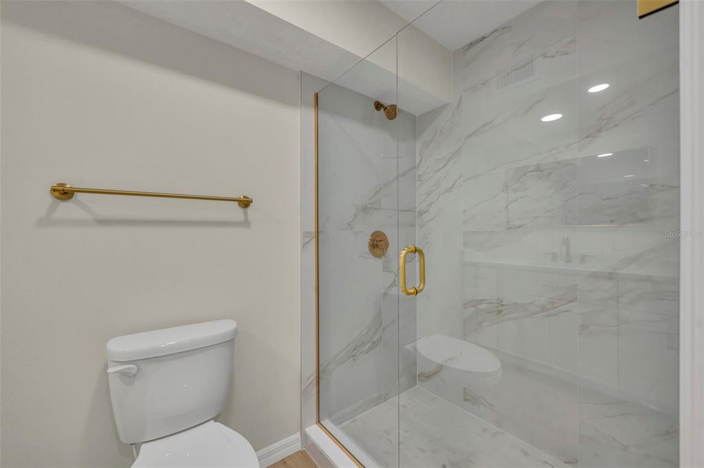 31201 Merry Road Tavares, FL 32778 - Photo 26 of 40 a bathroom with a toilet and shower