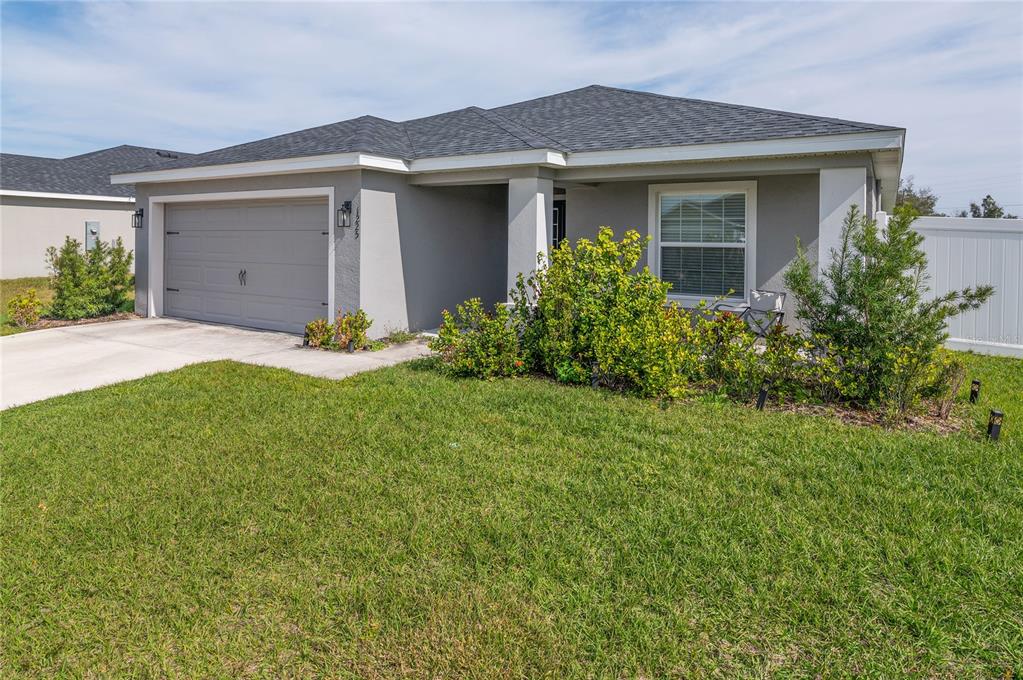 a front view of house with yard and green space