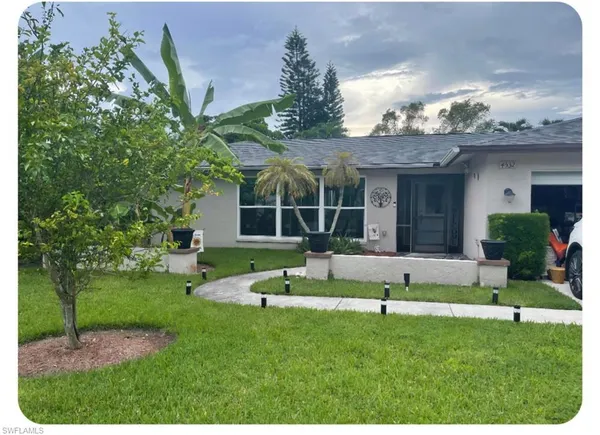 a front view of a house with a yard