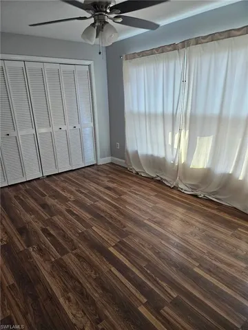 a view of a room with wooden floor and window