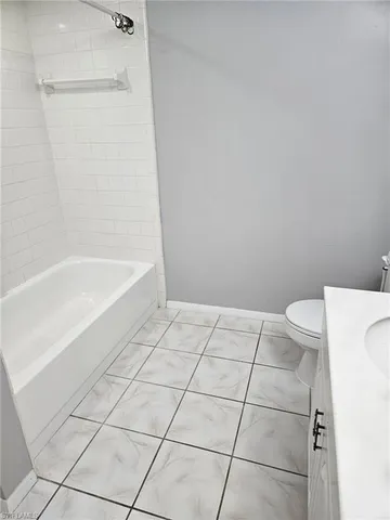 a bathroom with a bathtub and toilet