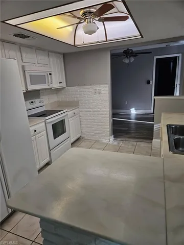 a kitchen with a stove and white cabinets