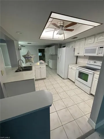 a kitchen with a sink and a stove top oven