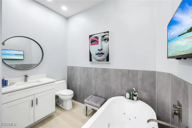 a bathroom with a toilet sink and mirror