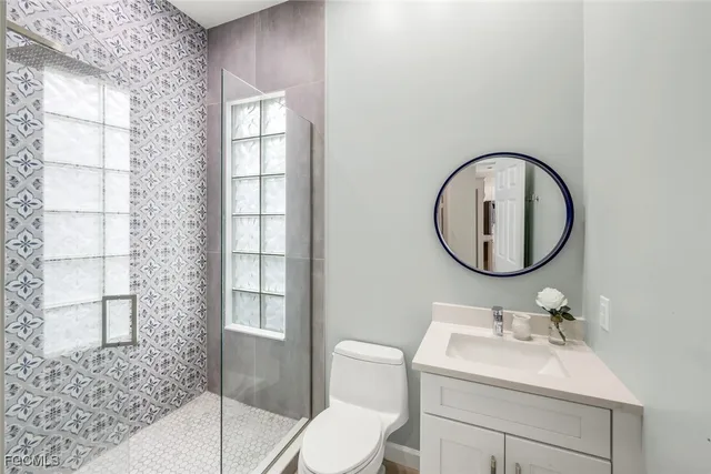 a bathroom with a sink toilet and a mirror