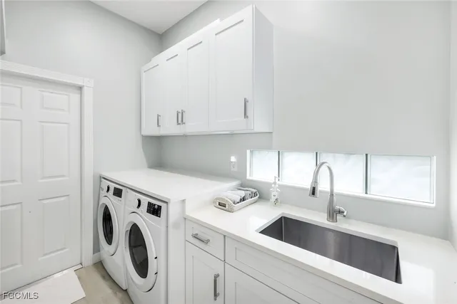 a view of a kitchen with sink washer and dryer