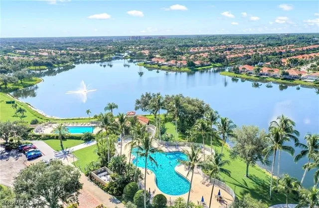 an aerial view of residential houses with outdoor space and lake view