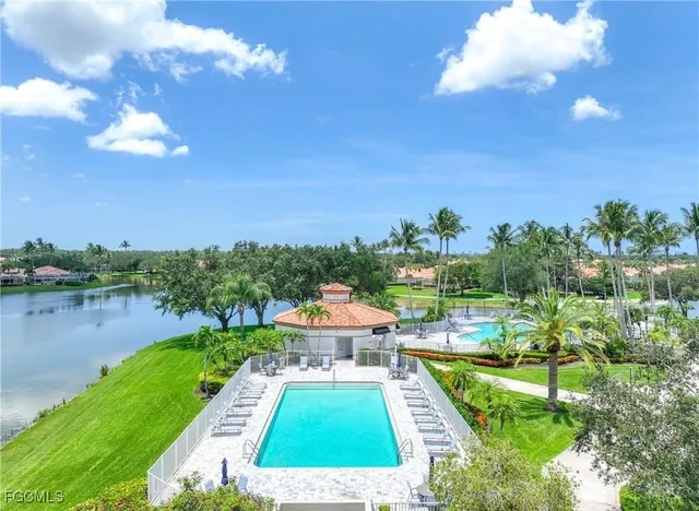 a view of a swimming pool and outdoor seating