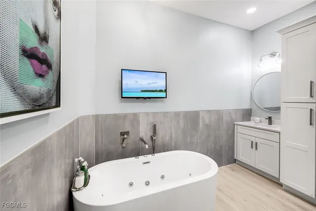 a bathroom with a tub and sink