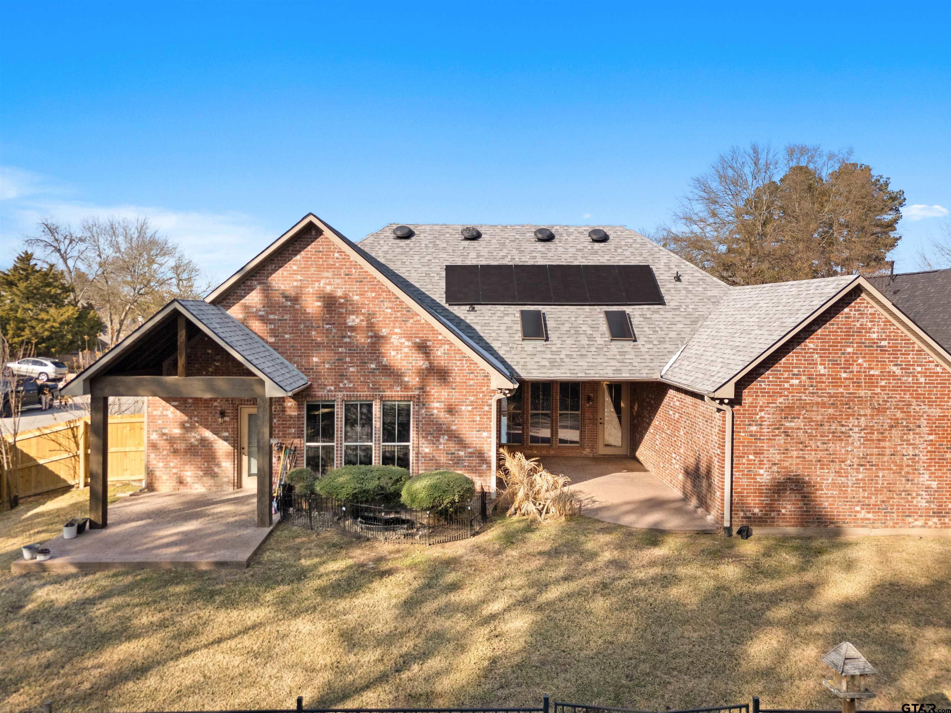 714 Huntwick Lane Tyler, TX 75703 - Photo 16 of 39 a front view of a house with a yard