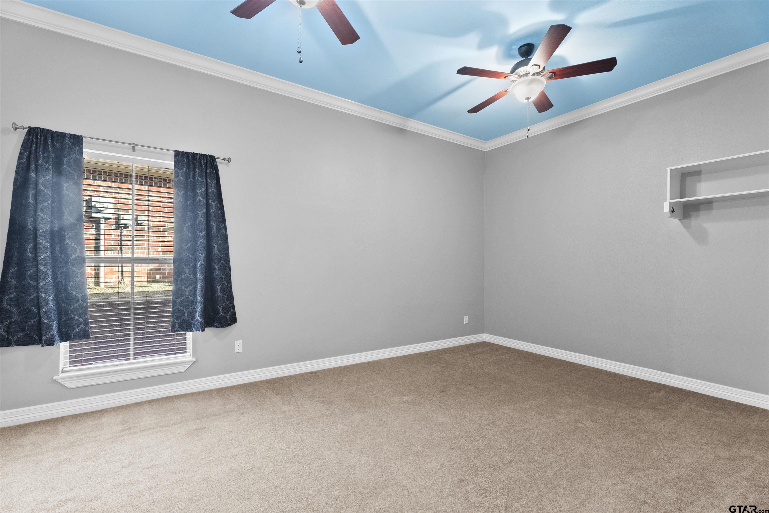 714 Huntwick Lane Tyler, TX 75703 - Photo 18 of 39 an empty room with a ceiling fan and window