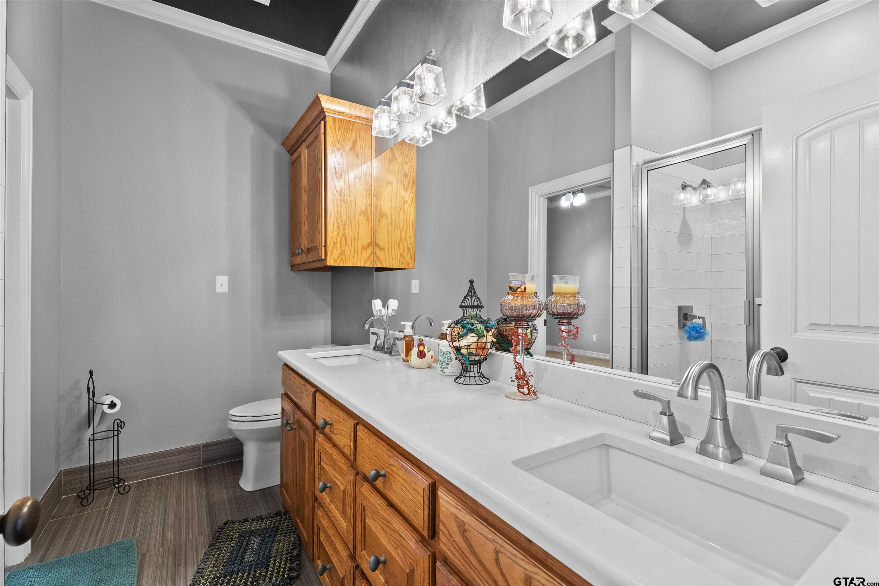 714 Huntwick Lane Tyler, TX 75703 - Photo 19 of 39 a bathroom with a toilet sink and mirror