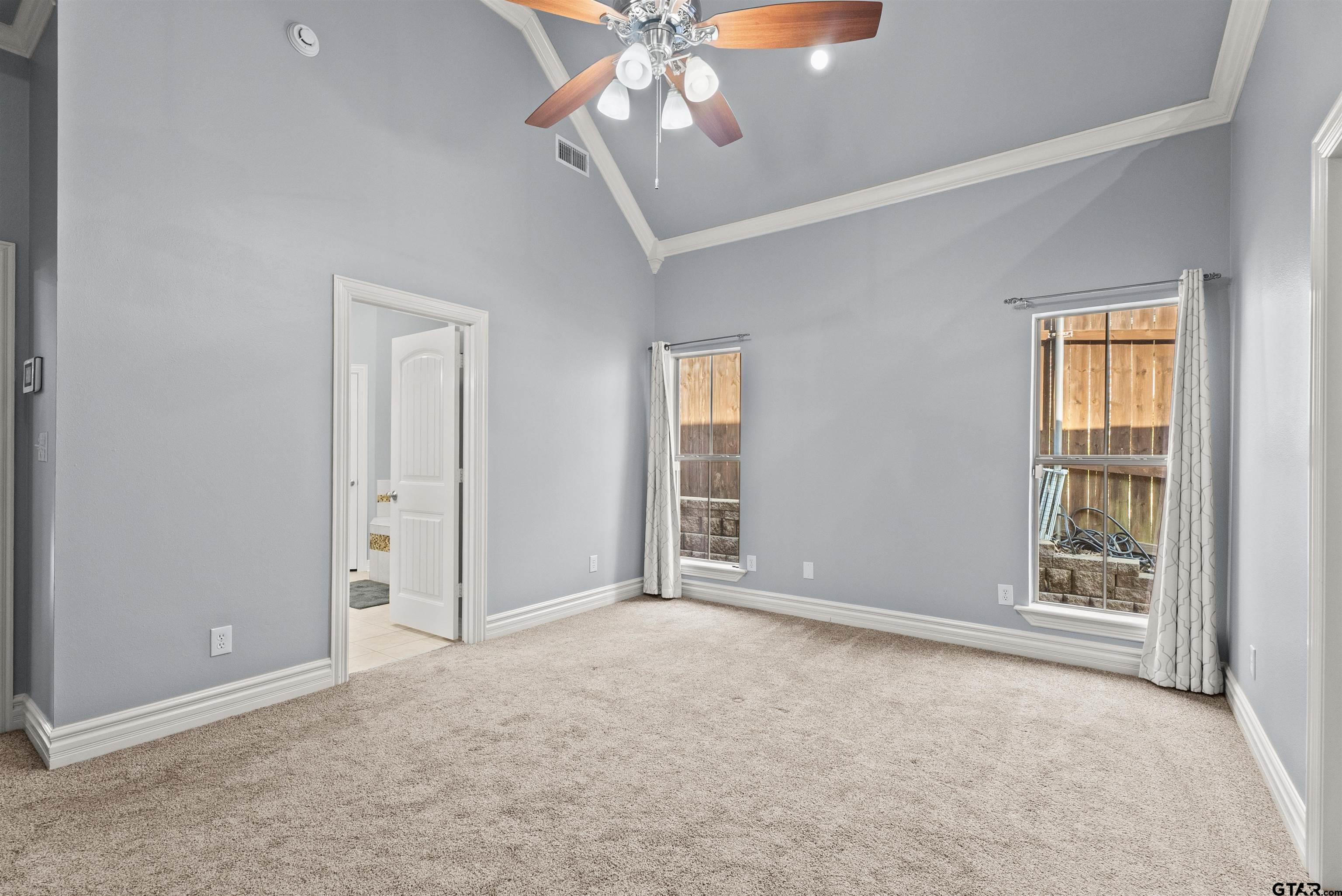 714 Huntwick Lane Tyler, TX 75703 - Photo 22 of 39 an empty room with chandelier fan