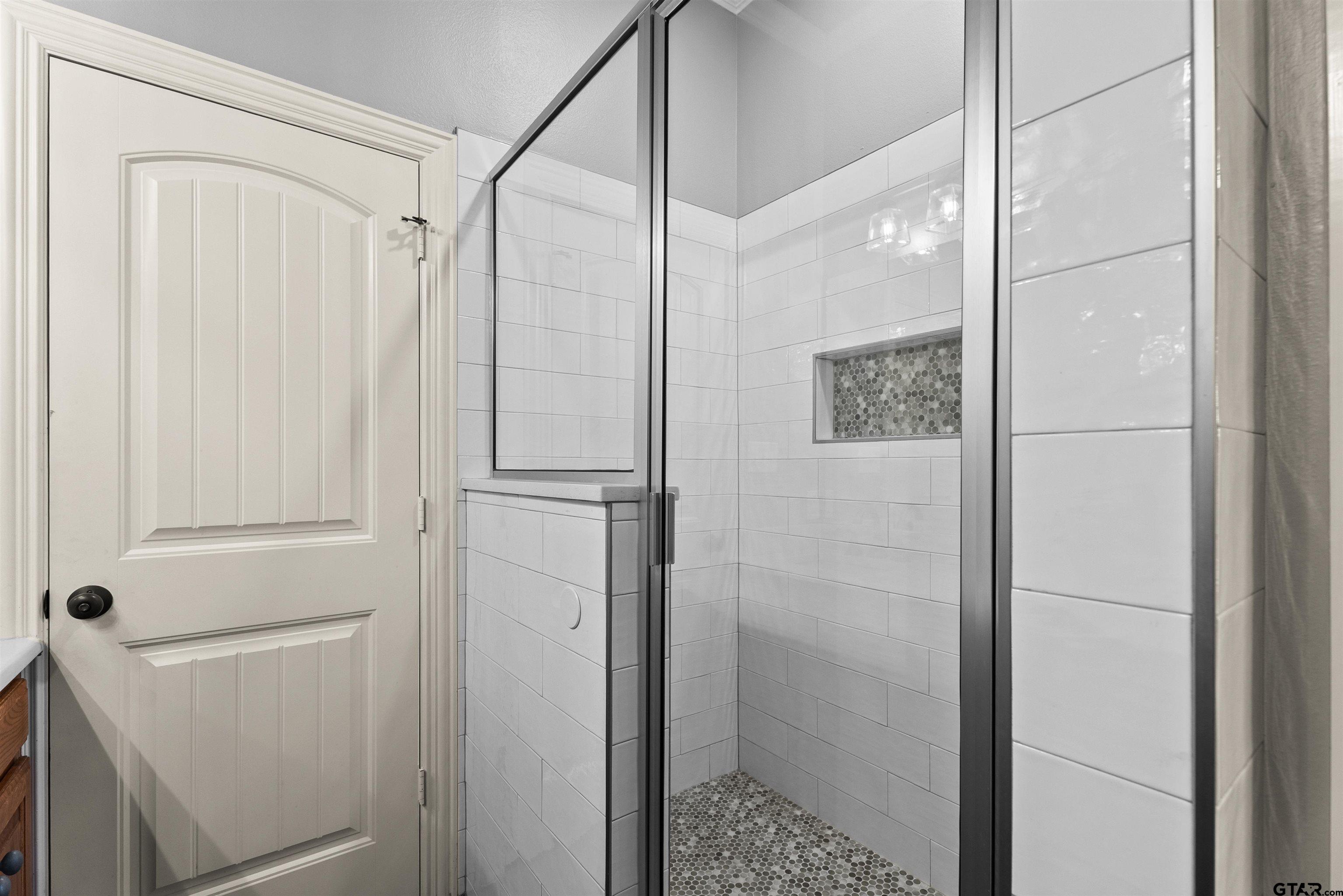 714 Huntwick Lane Tyler, TX 75703 - Photo 24 of 39 a bathroom with a shower and a glass door