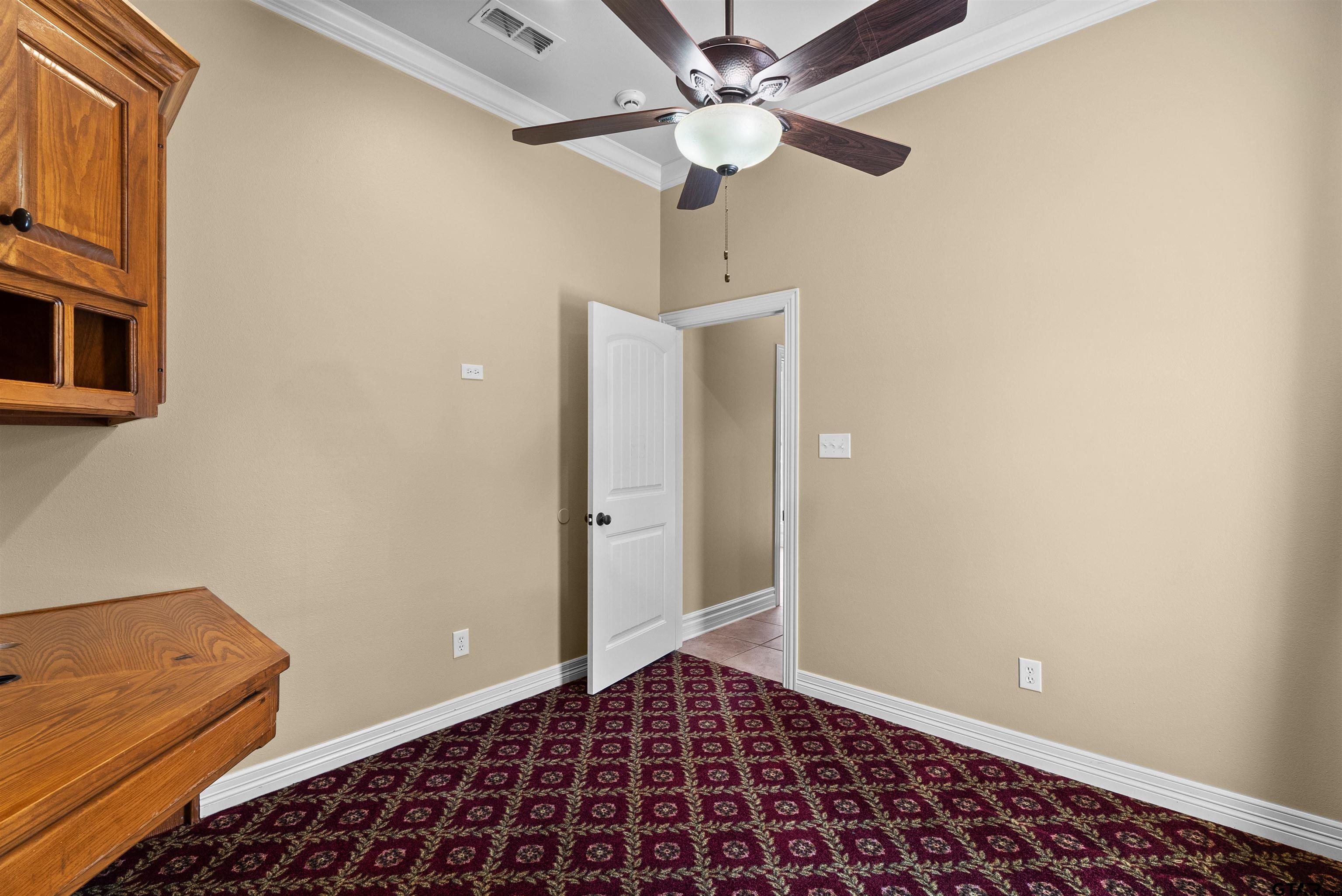 714 Huntwick Lane Tyler, TX 75703 - Photo 27 of 39 a view of a hallway with a chandelier