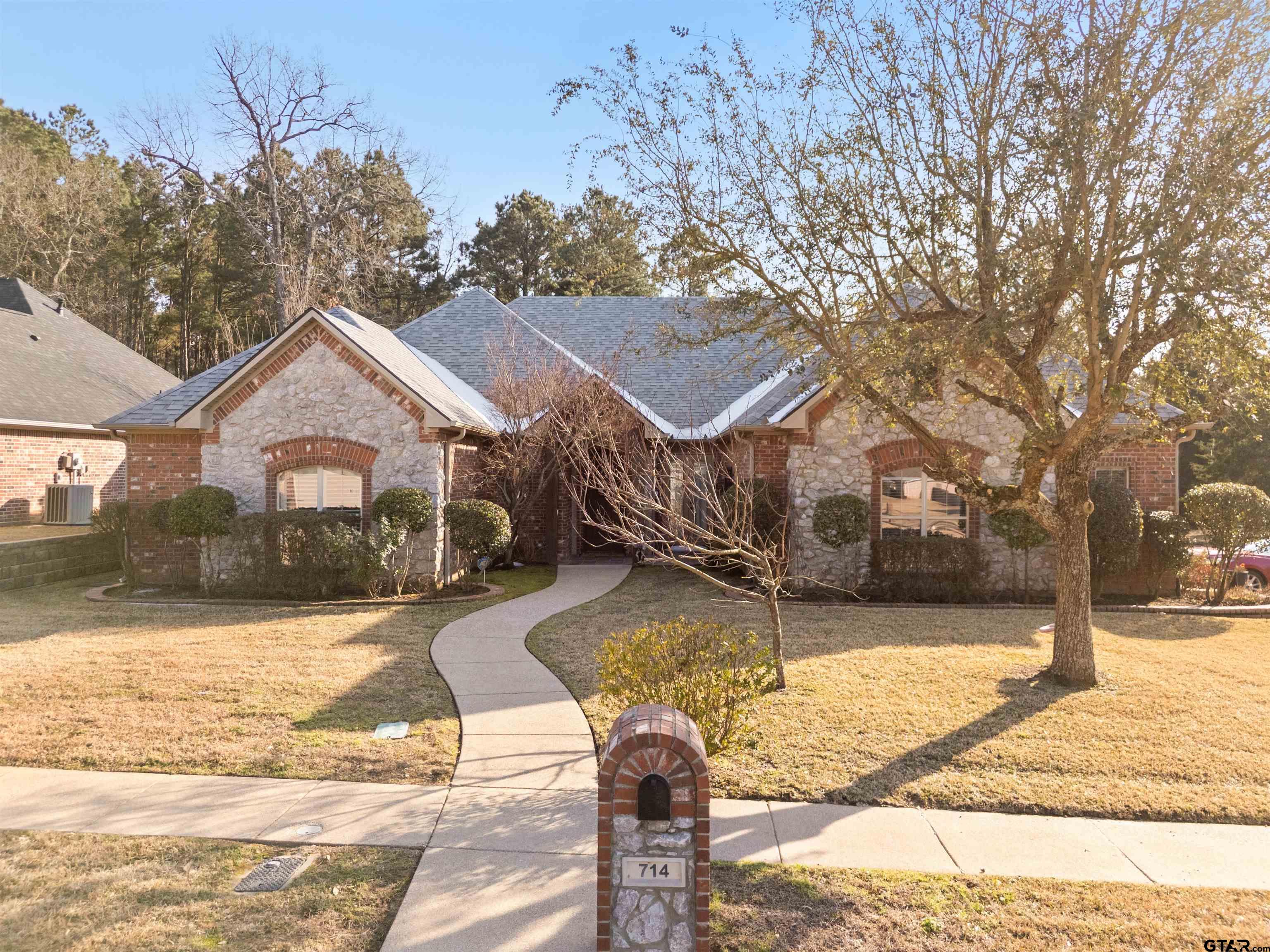 714 Huntwick Lane Tyler, TX 75703 - Photo 30 of 39 a front view of a house with a yard