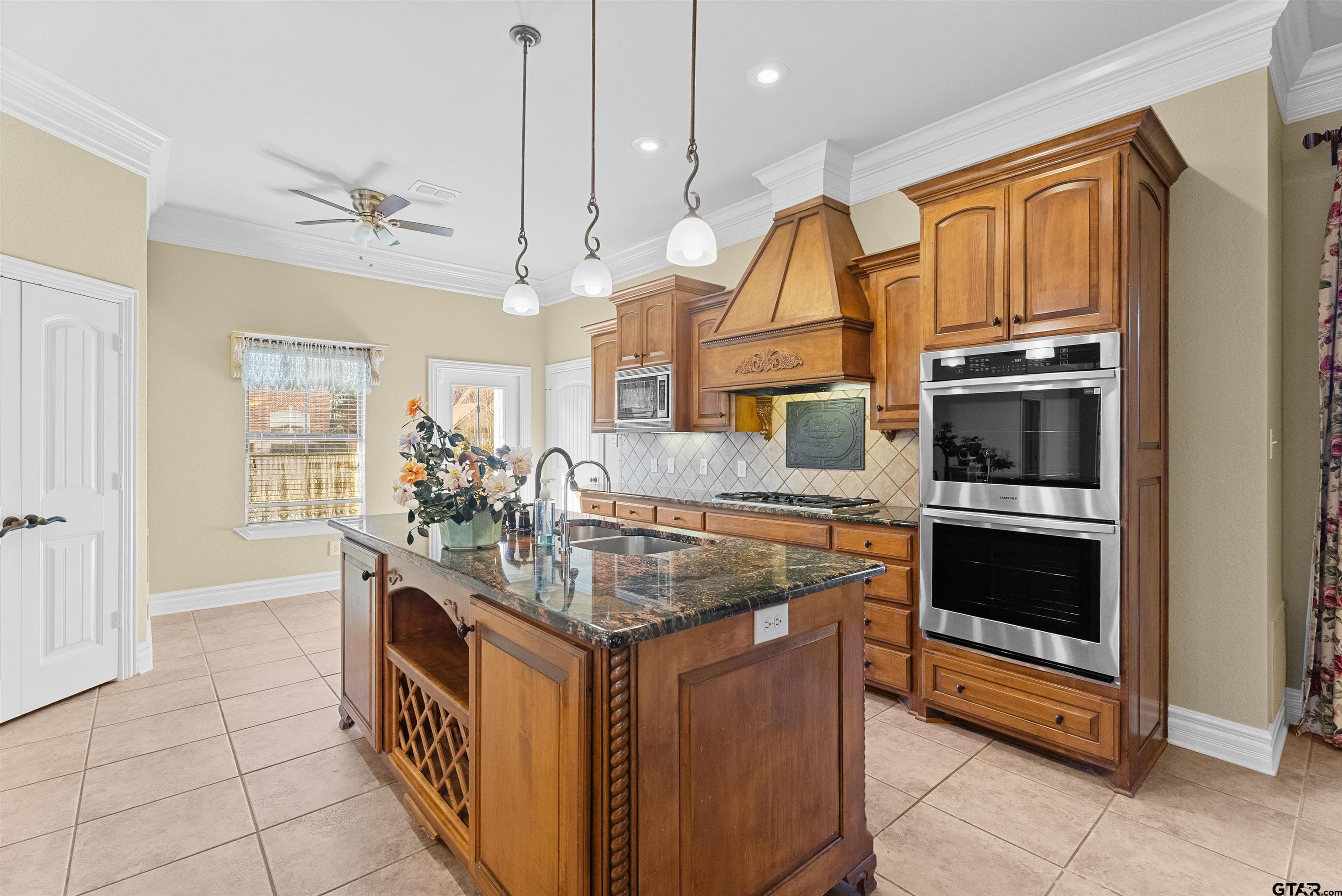 714 Huntwick Lane Tyler, TX 75703 - Photo 31 of 39 a kitchen with stainless steel appliances granite countertop a stove and a sink
