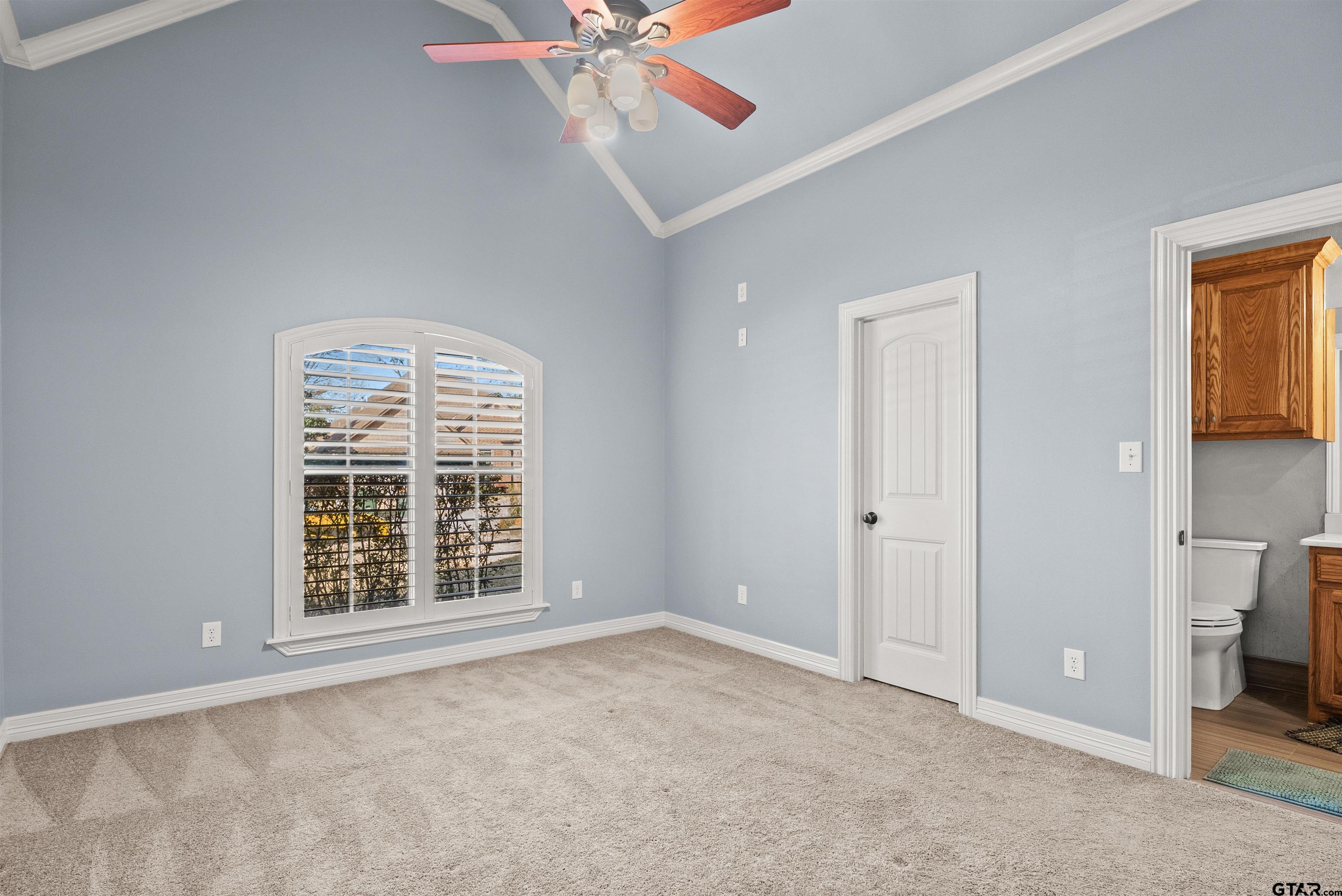 714 Huntwick Lane Tyler, TX 75703 - Photo 7 of 39 an empty room with windows closet and chandelier fan