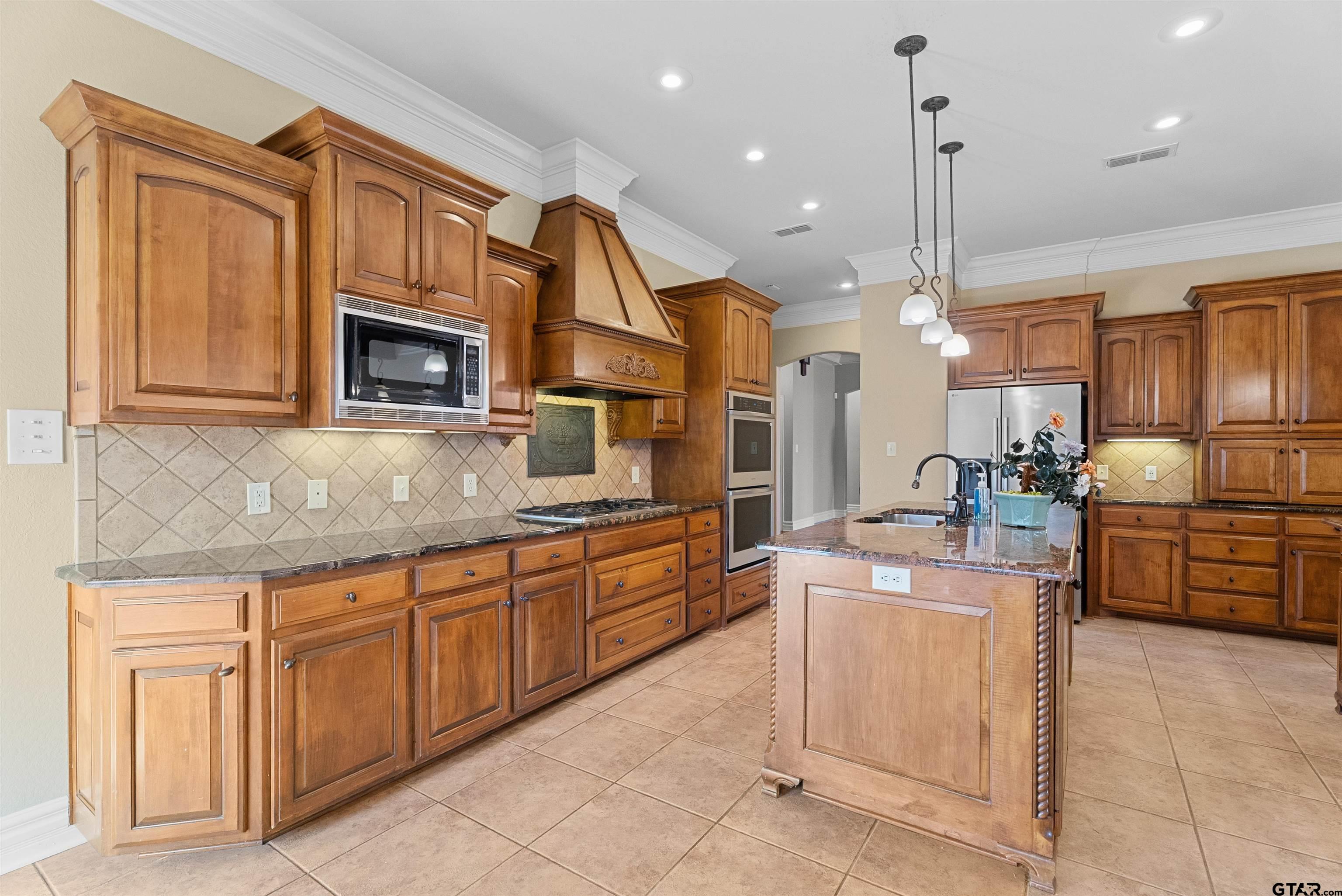 714 Huntwick Lane Tyler, TX 75703 - Photo 7 of 39 a kitchen with stainless steel appliances granite countertop a sink and cabinets