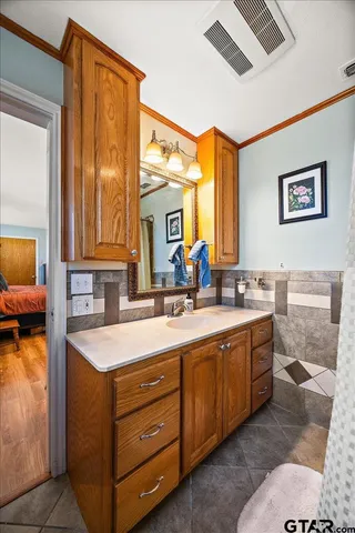 a spacious bathroom with a double vanity sink and a mirror