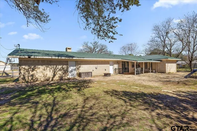 a view of a house with backyard and sitting area