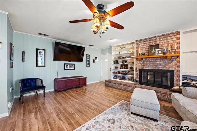 a living room with furniture fireplace and flat screen tv