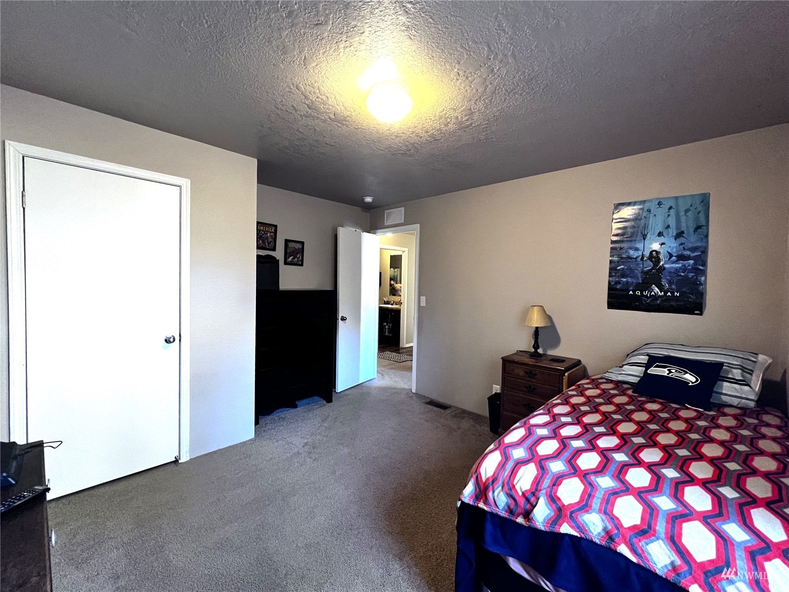 234 Boone Road Toledo, WA 98591 - Photo 13 of 33 a bedroom with a bed and a chandelier