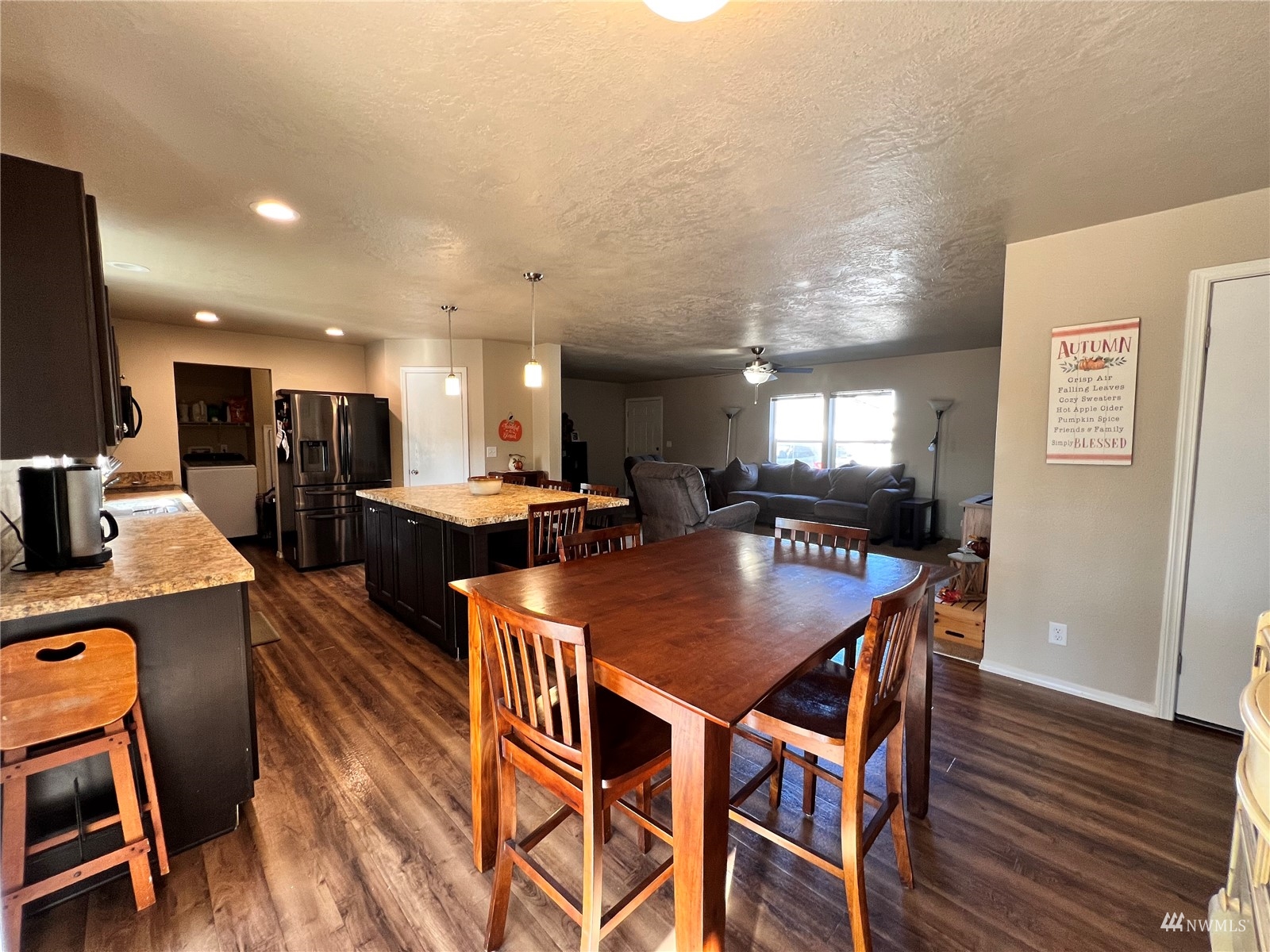 234 Boone Road Toledo, WA 98591 - Photo 7 of 33 a dining room with furniture a wooden floor and a kitchen