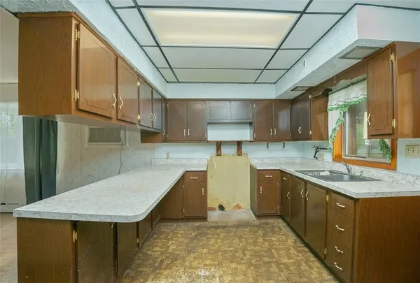 a kitchen with stainless steel appliances granite countertop a sink a stove counter space and cabinets