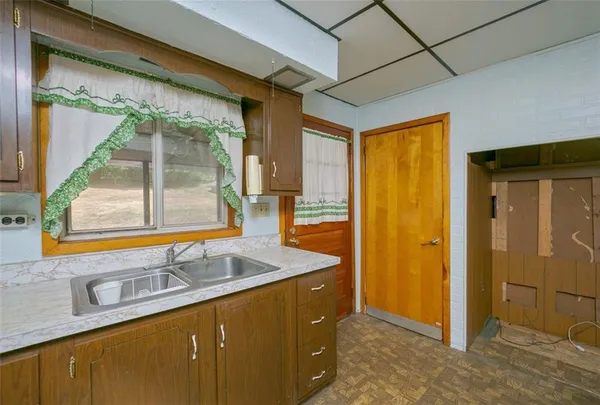 a bathroom with a granite countertop sink and a large mirror