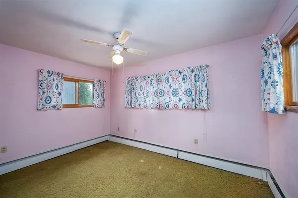 a view of room with hardwood floor and ceiling fan