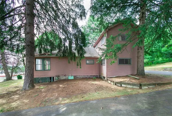 a view of a house with a tree and plants