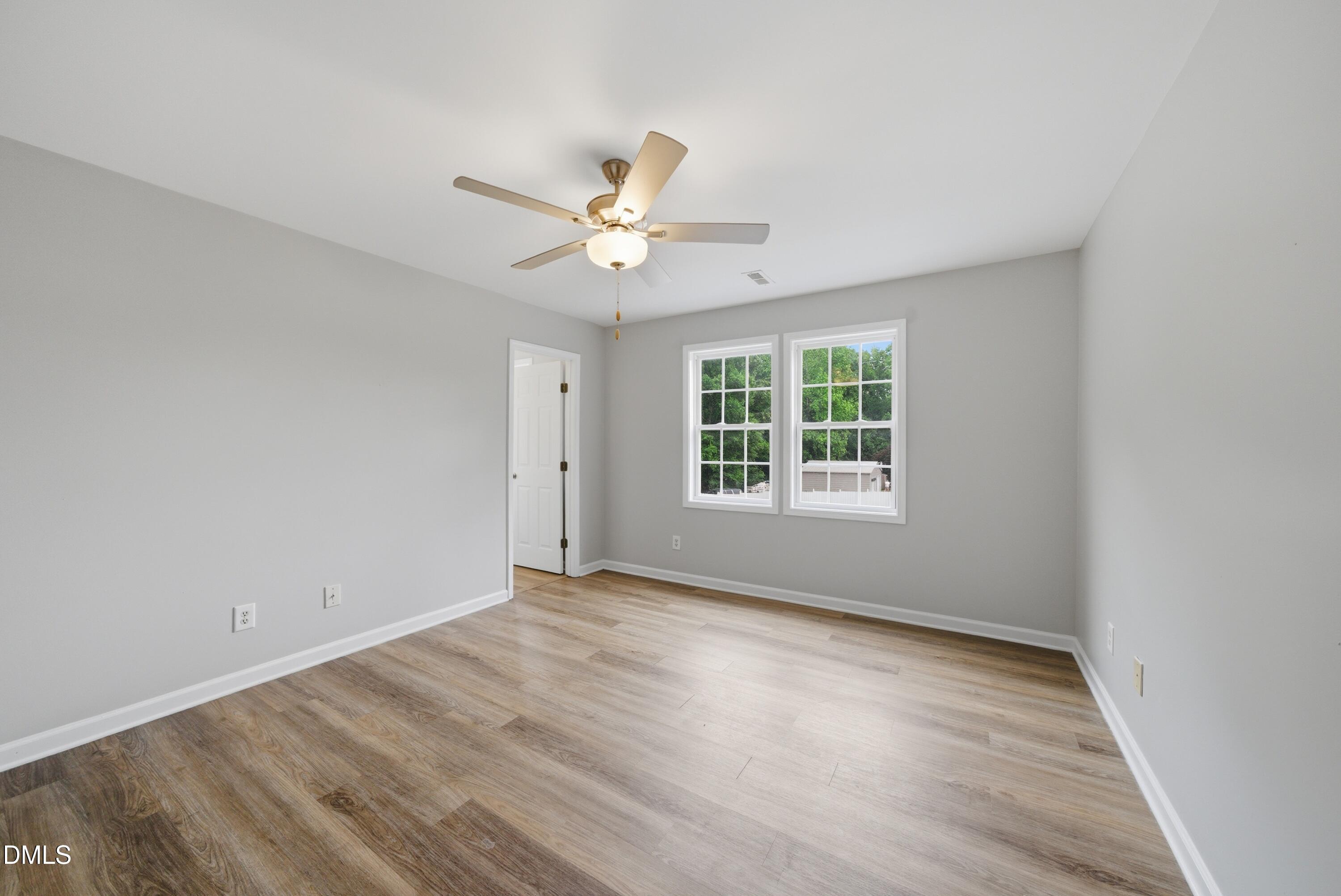 201 Tonylee Court, Unit A Raleigh, NC 27603 - Photo 23 of 30 an empty room with wooden floor and windows
