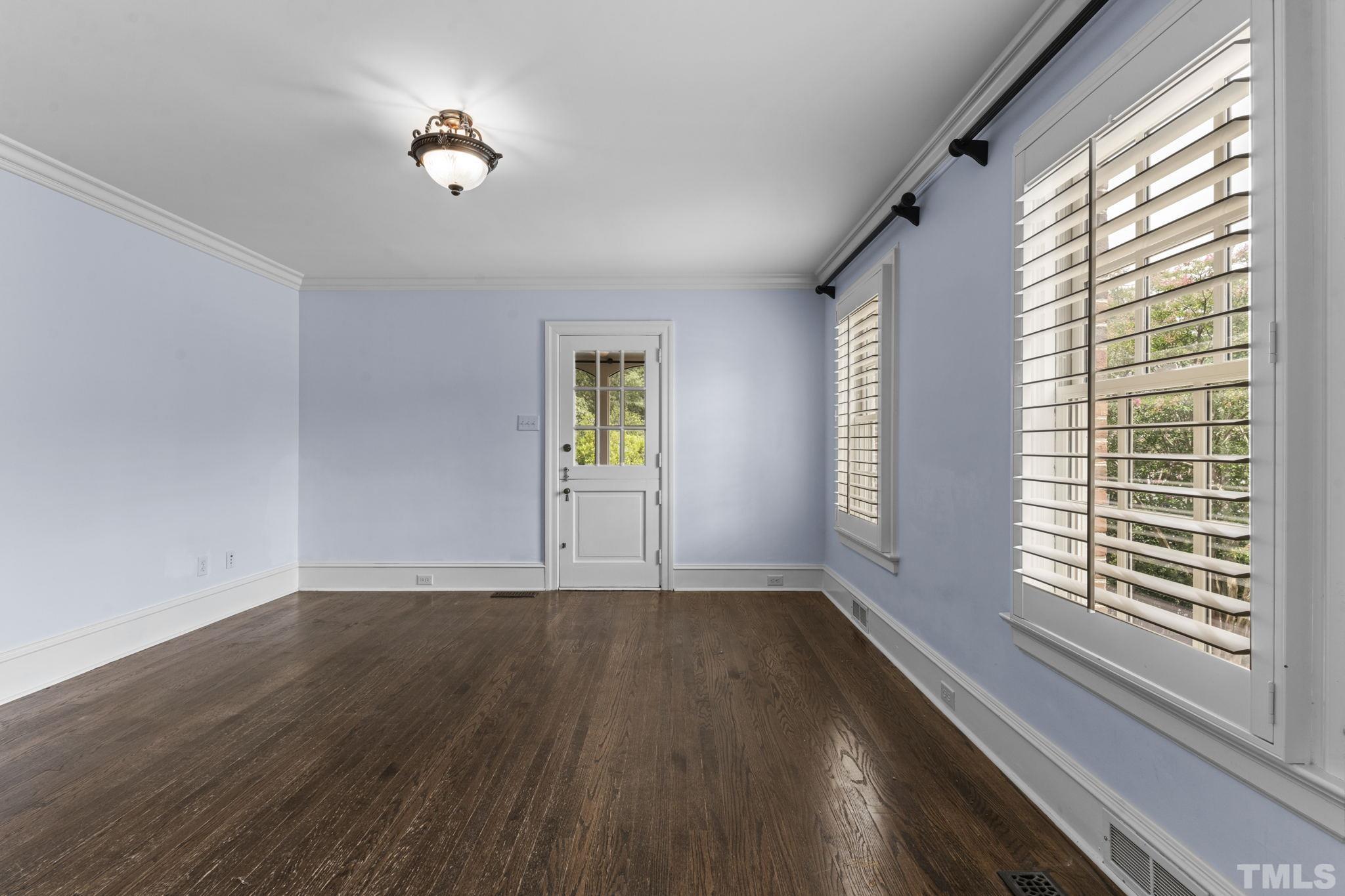224 Hawthorne Road Raleigh, NC 27605 - Photo 13 of 46 a view of an empty room with a window and wooden floor