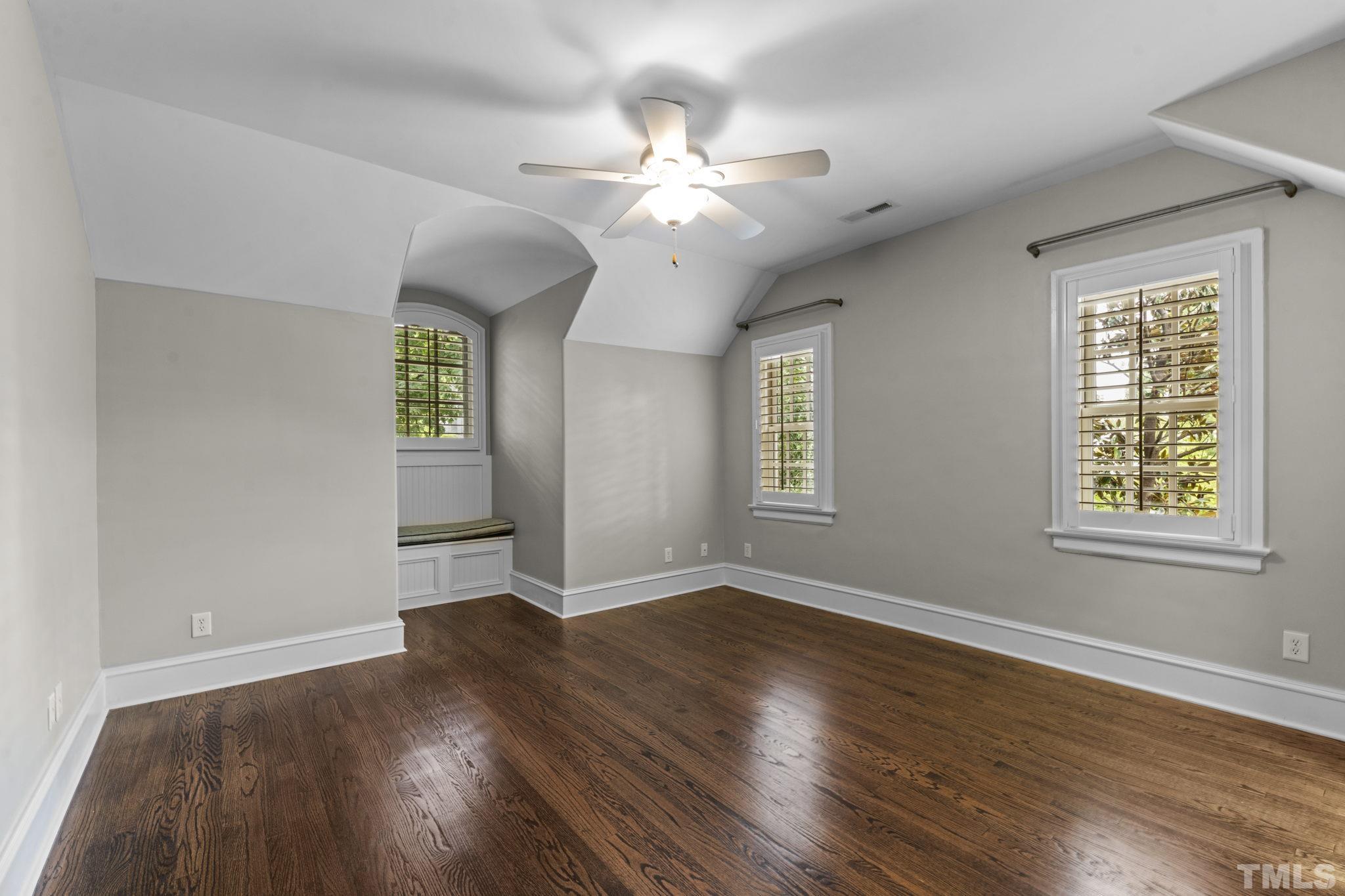 224 Hawthorne Road Raleigh, NC 27605 - Photo 27 of 46 a view of an empty room with wooden floor and a window