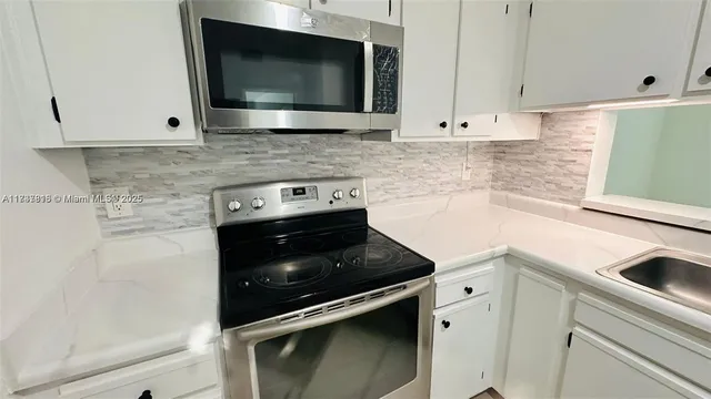 a kitchen with a stove and a microwave