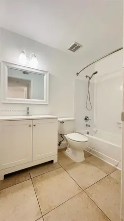 a bathroom with a toilet sink and shower