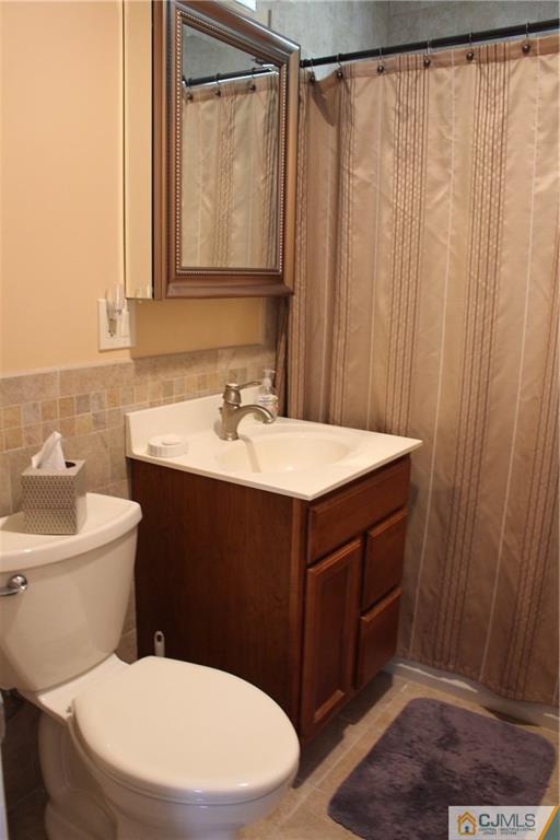 32 Gurley Road Edison, NJ 08817 - Photo 15 of 20 a bathroom with a sink a toilet and shower