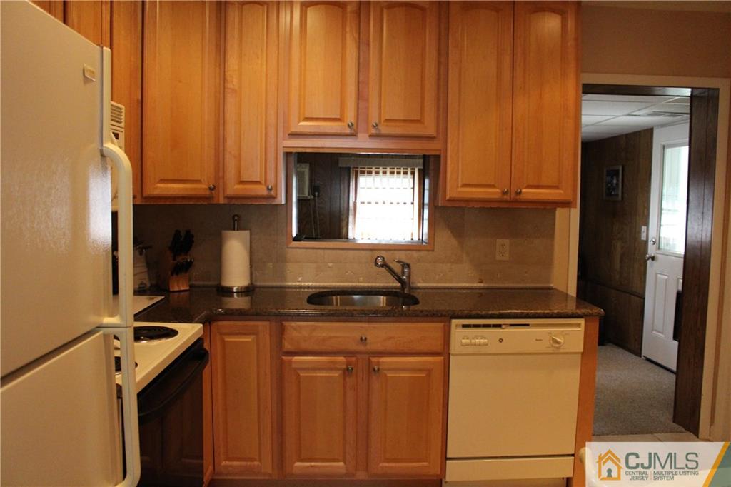 32 Gurley Road Edison, NJ 08817 - Photo 5 of 20 a kitchen with granite countertop a sink a stove and cabinets