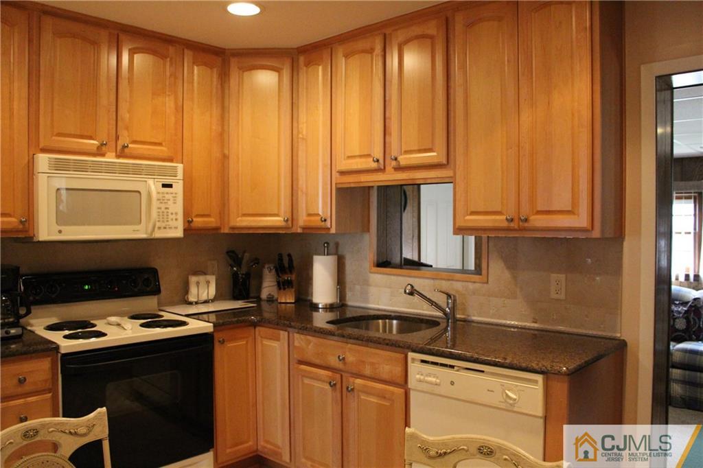 32 Gurley Road Edison, NJ 08817 - Photo 6 of 20 a kitchen with stainless steel appliances granite countertop a stove a sink and a microwave