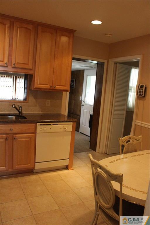 32 Gurley Road Edison, NJ 08817 - Photo 10 of 20 a kitchen with granite countertop a sink a stove cabinets and a dining table